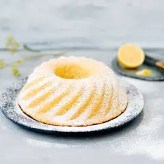 En vackert pudrad sockerkaka med citron, redo att avnjutas. Perfekt för dig som vill baka med citron.