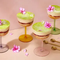 Fyra vackra prinsesstårtor i glas, dekorerade med blommor och pudrade med florsocker. En festlig dessert!